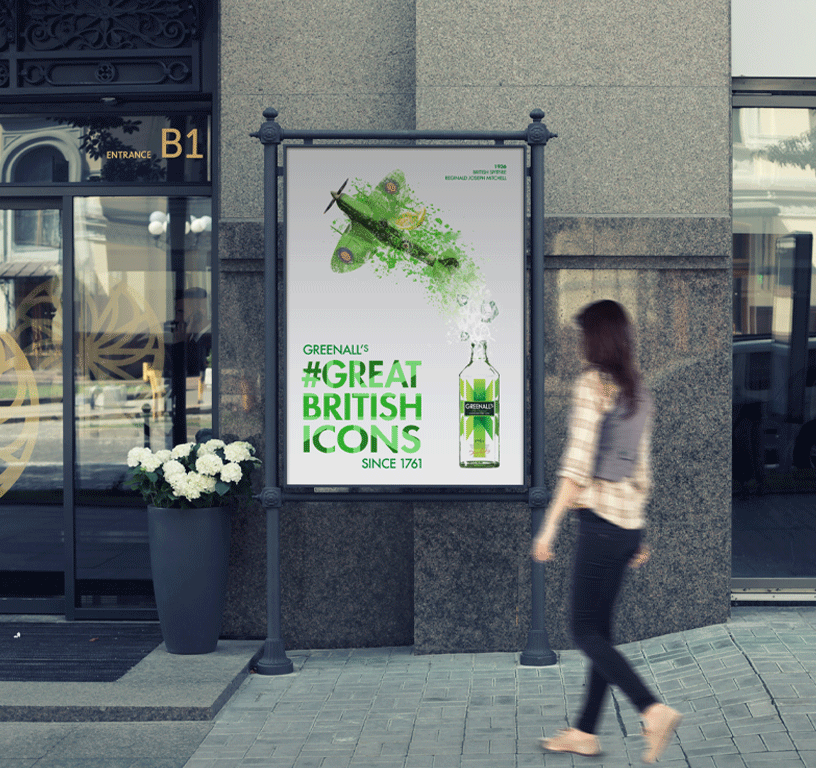 Woman walking past eco campaign billboard titled “Great British Icons.”